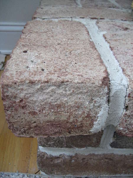 I have this loose brick which separated from the mortar cleanly.  I am wondering the easiest way toget stuck back in there