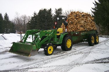 About 7.5 Face cord on old converted barrel spreader. JD 4400 tugged it home from the neighbors wood processor.