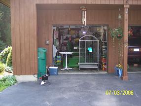 This is where I store my tractor.  My wife leaves all kinds of things in the way and has the garage packed full!  Those are bird cages and a stand she just cleaned out.  My car sits outside.   