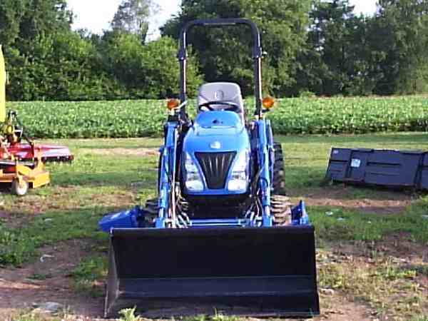 New Holland TC24DA W/ loader and mid mount mower